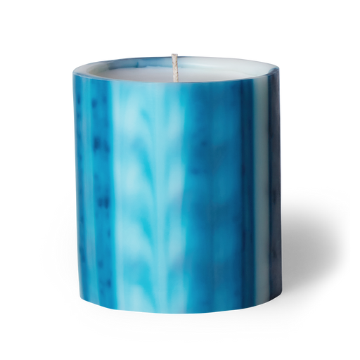 Immerse yourself in romance with Ciel scented artisanal candle. Night blooming jasmine, gardenia, and musk create transportive swells. Crafted underwater from wax, each candle is unique. Hand-poured in LA with cruelty-free coconut apricot wax. Enjoy over 75 hours of burn time. Paraben-free. Natural fragrance.  Image of ciel scented candle in blue wax vessel.