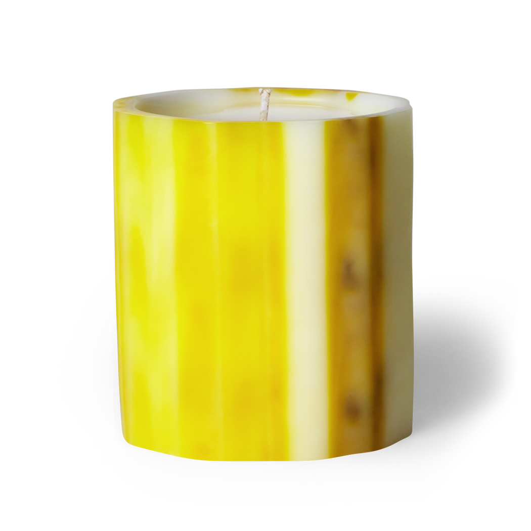 Invigorate your senses with Citron scented artisanal candle. Grapefruit, apple, and bergamot—tangy grapefruit and clarifying apple welcome this new day. Crafted underwater from wax, each candle is unique. Hand-poured in LA with coconut apricot wax. Cruelty-free ingredients. Non-toxic. Enjoy over 75 hours of burn time. Image of citron scented candle in yellow wax vessel.