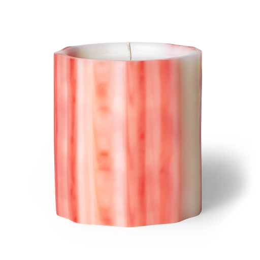  Awaken the senses with fleur scented artisanal candle. Neroli blossom, hibiscus, and citrus peel evoke the vibrance of spring. Handcrafted underwater from wax, each candle is a unique creation. Hand-poured in LA with cruelty-free coconut apricot wax. Enjoy over 75 hours of burn time. Image of fleur scented candle in pink colored waxed vessel. 