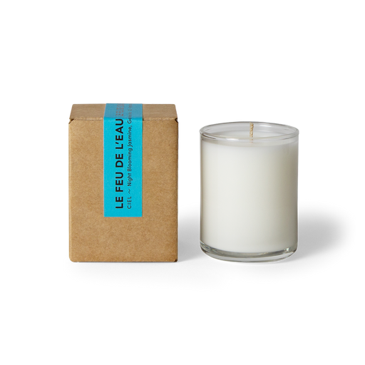 Indulge in the 3oz Ciel glass candle, blending night blooming jasmine, gardenia and musk. Hand-poured in LA, cruelty-free, with coconut apricot wax, natural fragrance, and lead-free cotton wicks. No harmful additives. The candle is displayed unboxed, positioned beside its packaging, set against a clean white backdrop.